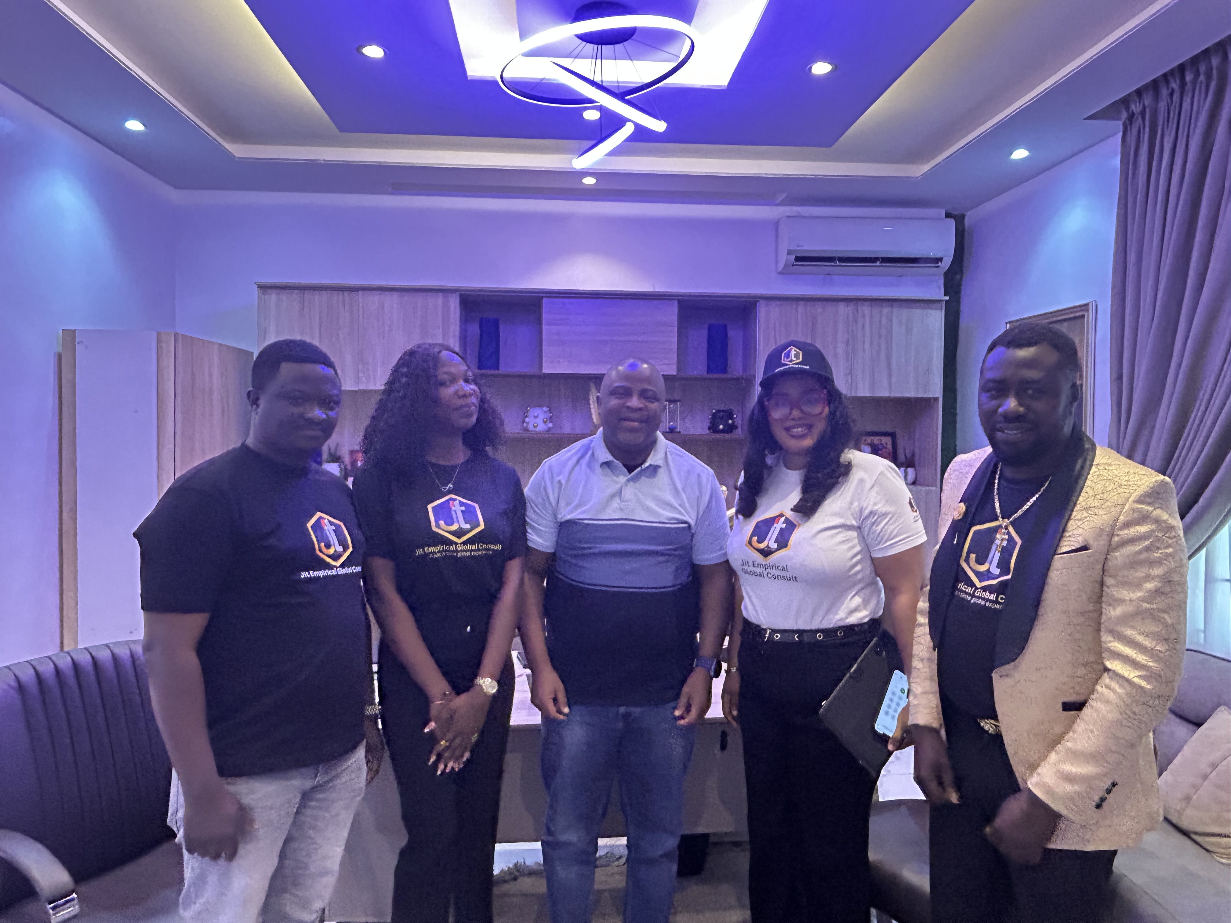 Members of the JIT team gathered together in branded shirts.